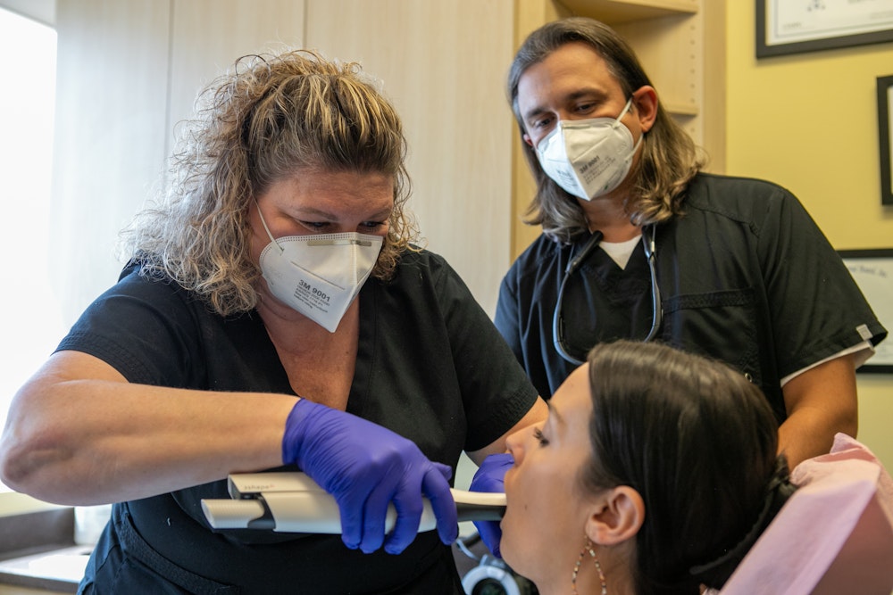 Dr. Ace with a teamember and patient