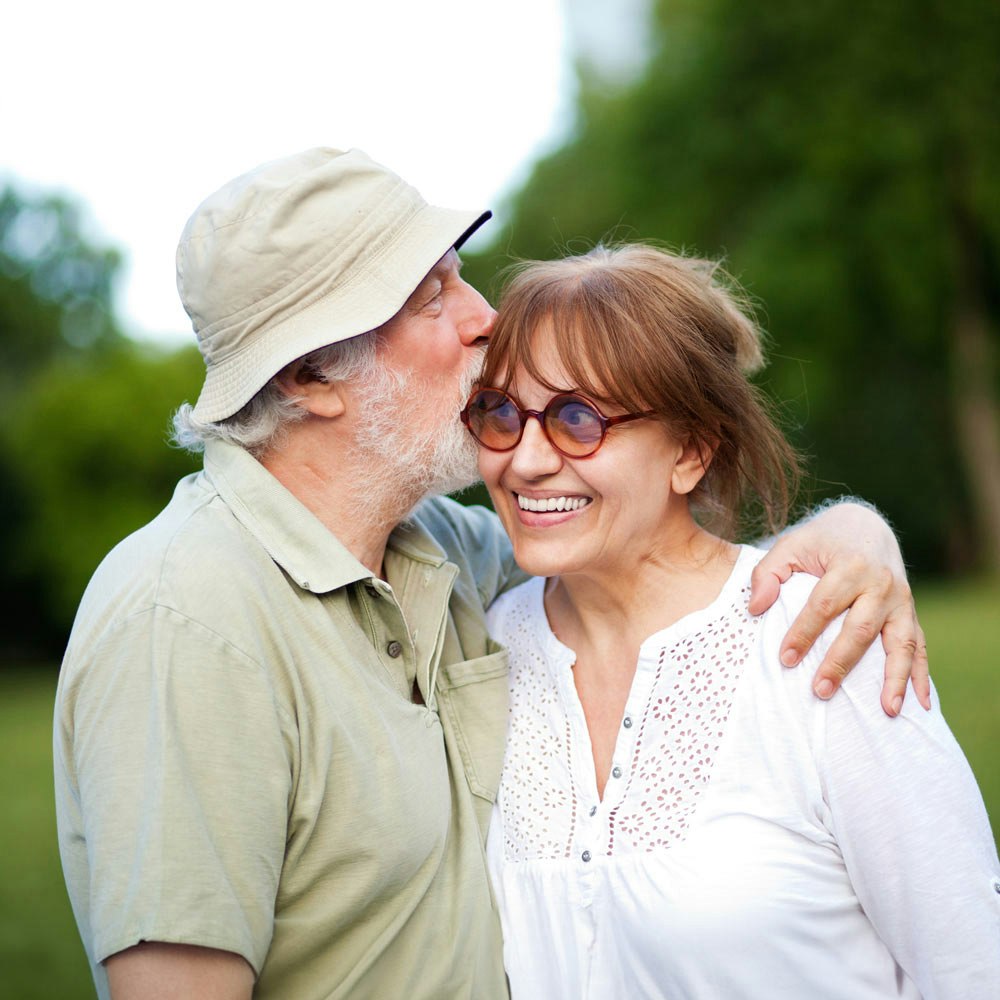 Older woman embracing partner after a tooth extraction