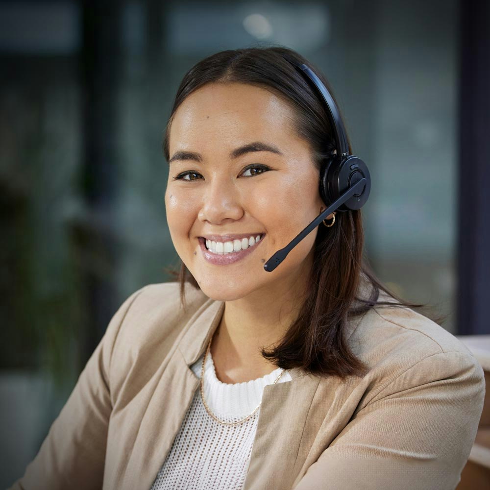 Smiling woman wearing headset at work