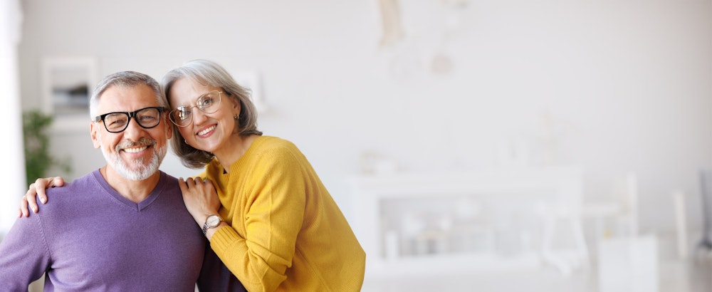 Smiling couple with dental crowns