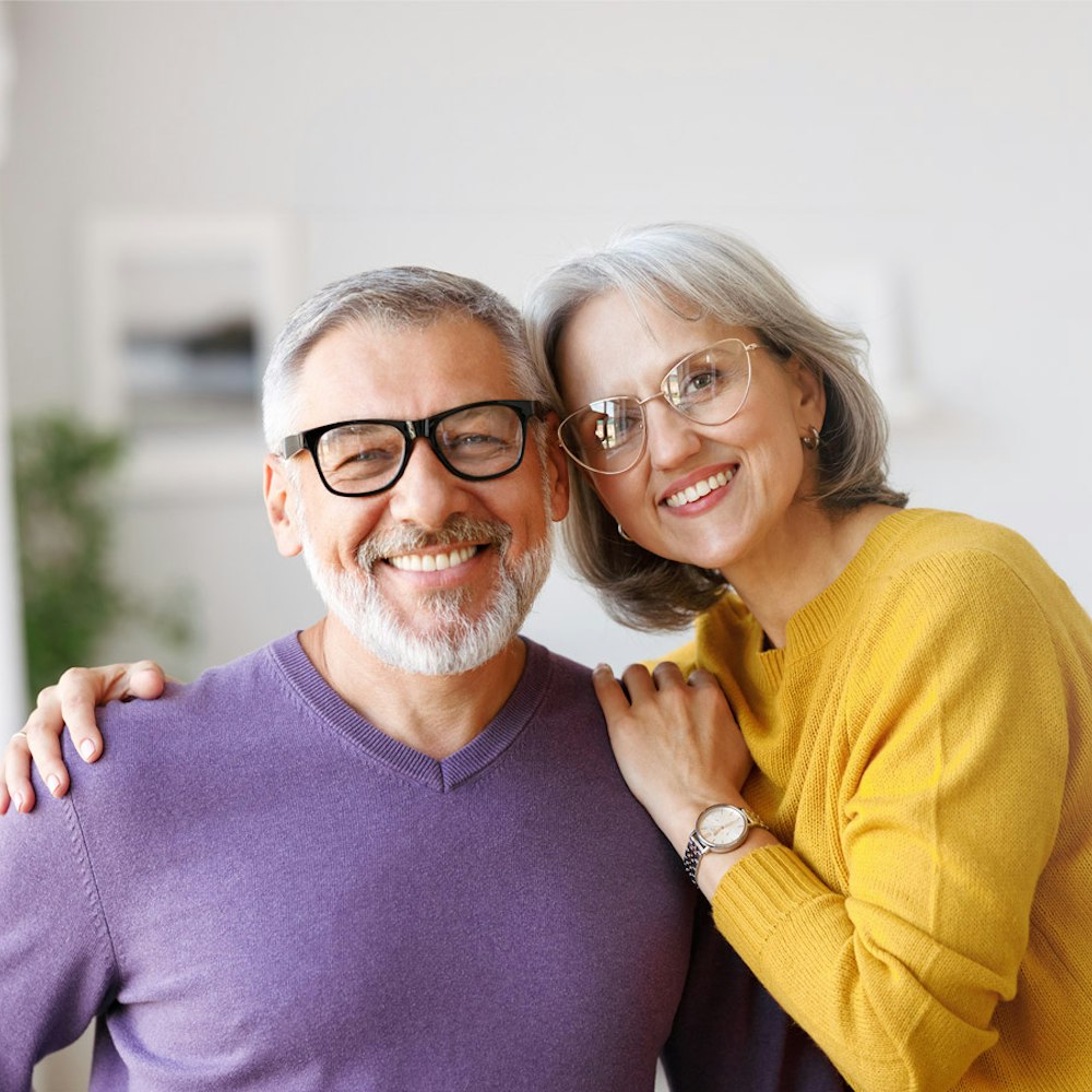 Smiling couple with dental crowns
