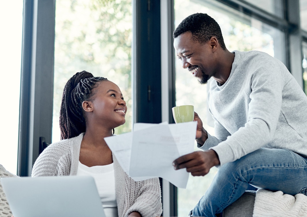 Smiling couple looking at paperwork together