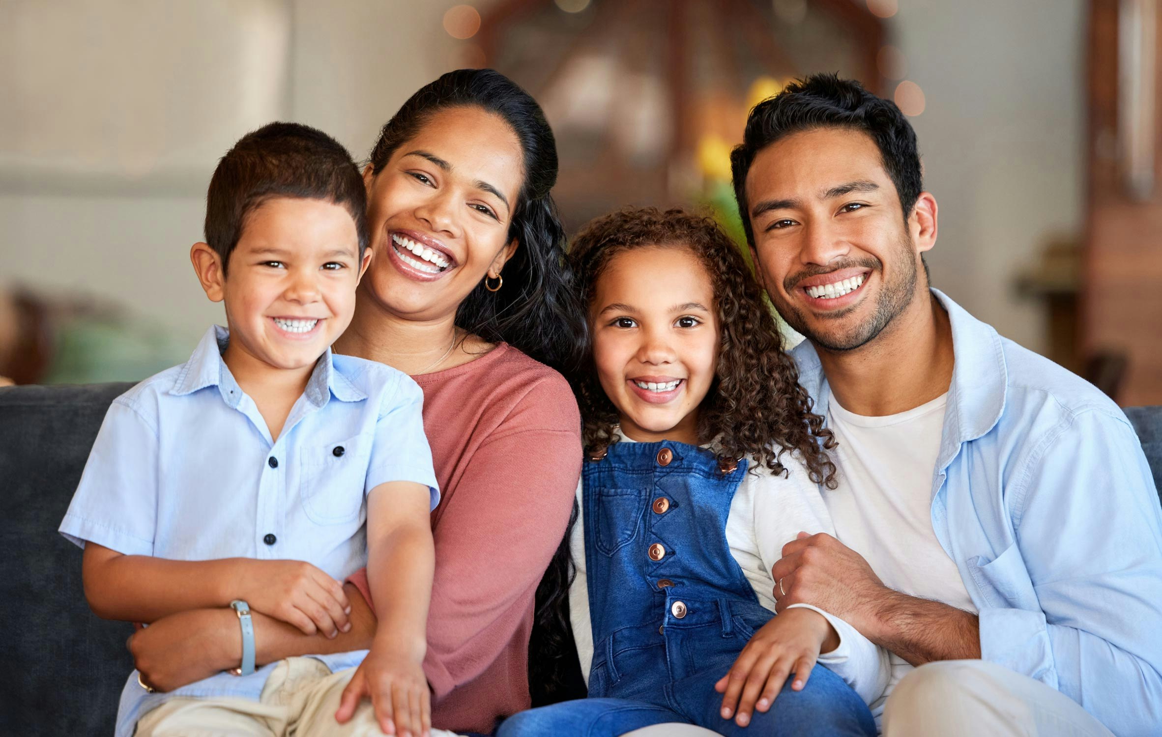 Happy smiling family with 2 young kids