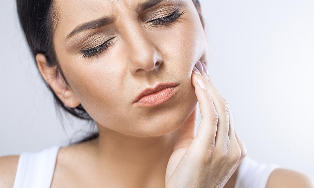 Woman Holding her Jaw in Pain