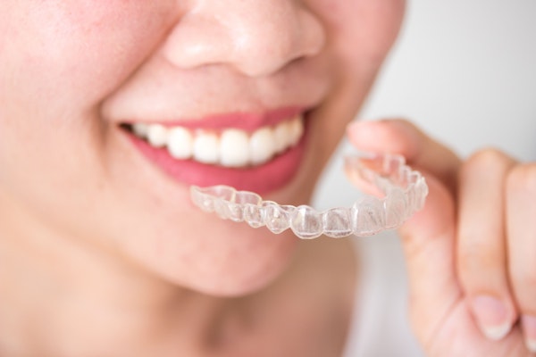 Girl with Invisalign tray