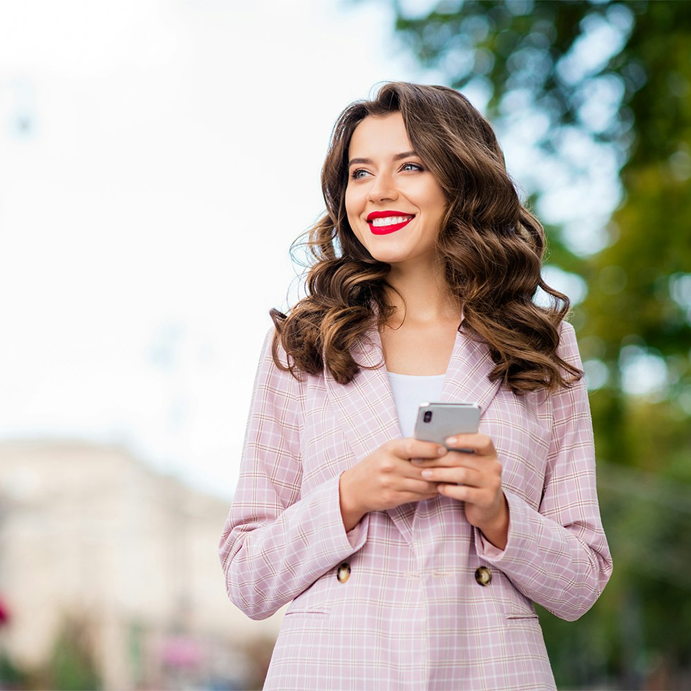 Girl walking and texting while smiling