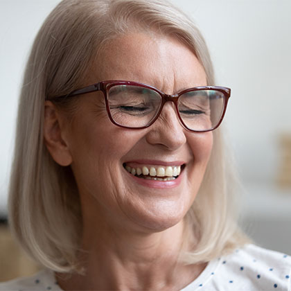 Older woman smiling with glasses