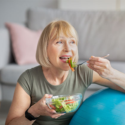 Older woman eating a salad