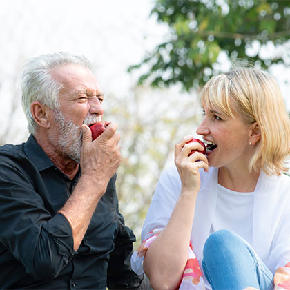 Older couple eating apples