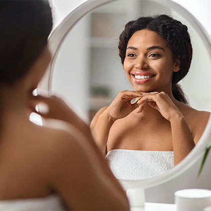 Girl smiling in a mirror