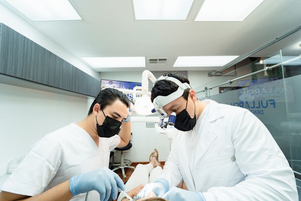 Dentists performing dental care on a patient
