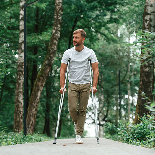 Man outside on crutches