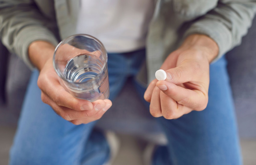 man taking pain medication