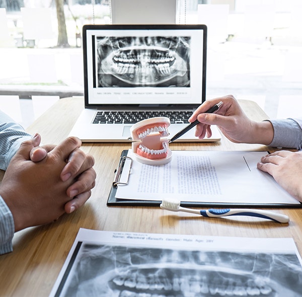 Dentist and patient discussing Invisalign treatment plan