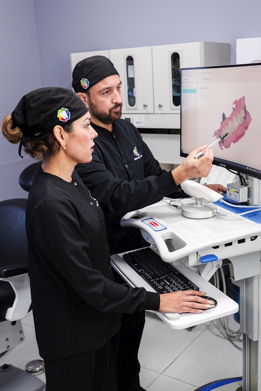 Dr. Pelayo and Dr. Acosta looking at digital scan