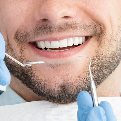 Dental instruments next to root canal patient's mouth