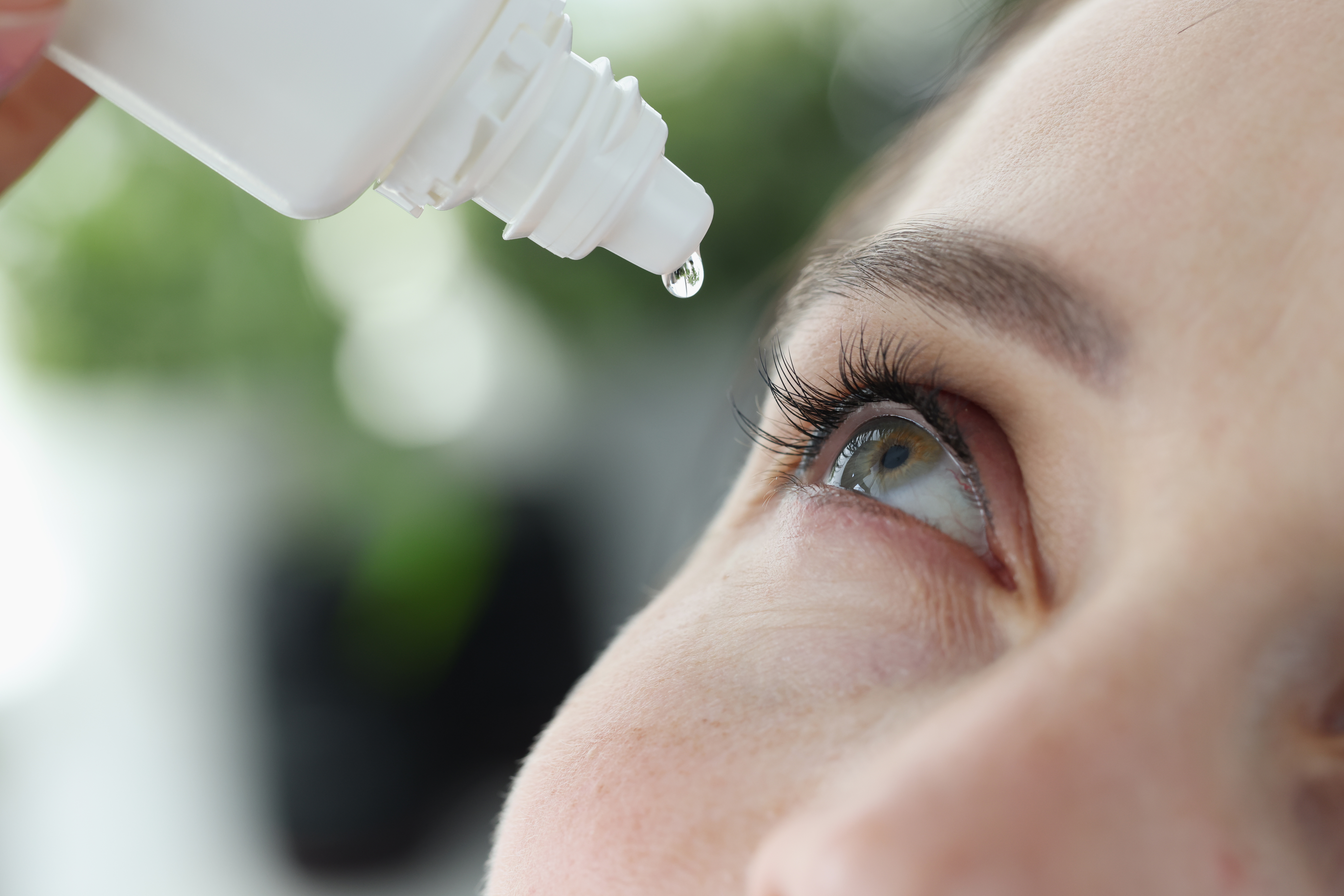 Woman Applying Eye Drops