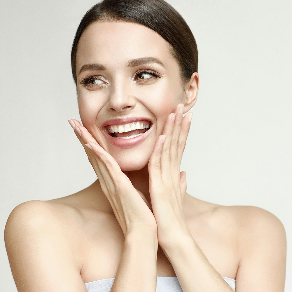 Young woman smiling with perfect skin