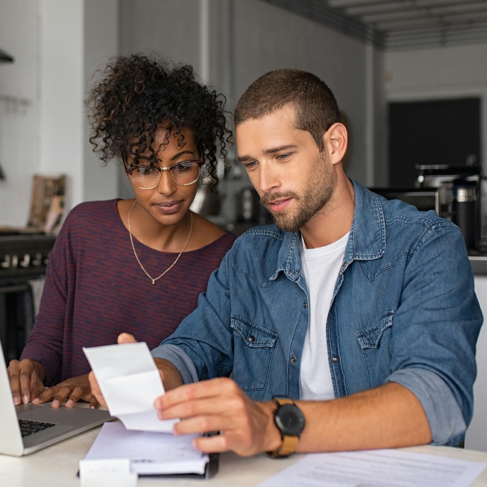 Couple in debt looking at paperwork