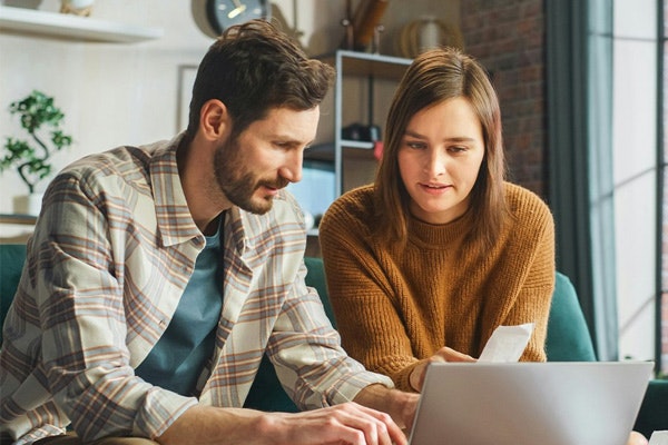 Couple on laptop discussing filing for bankruptcy