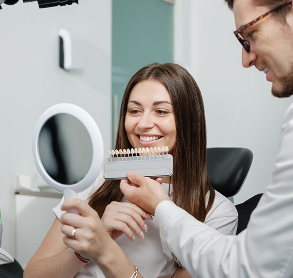 dentist showing patient her veneers options