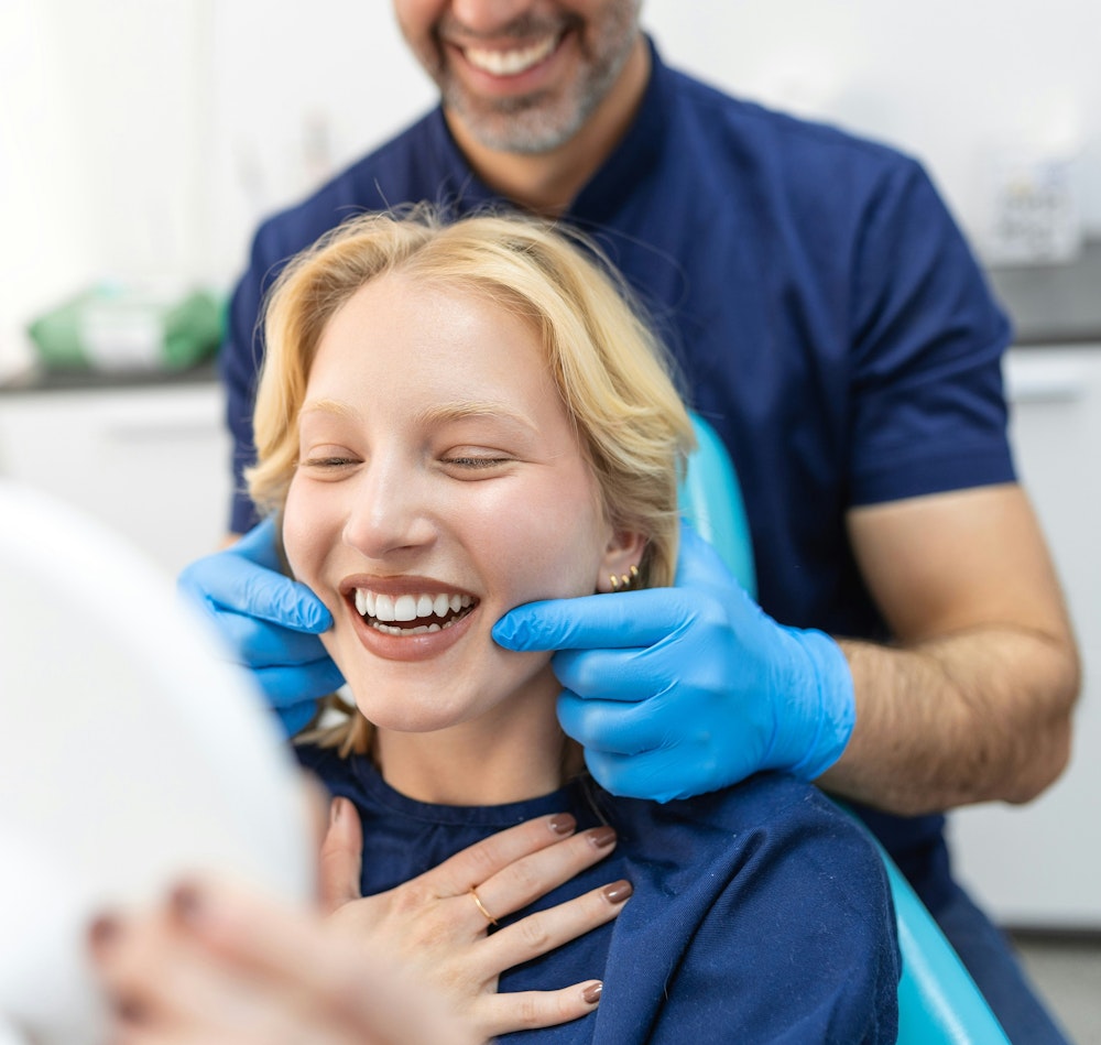 Dental patient looking at smile in mirror