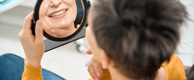 patient smiling in mirror