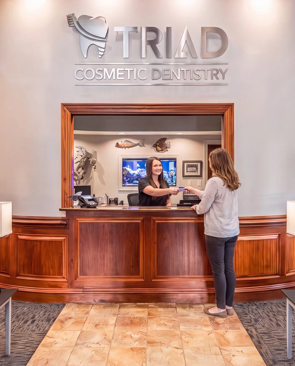 patient pays for treatment at Triad Cosmetic Dentistry