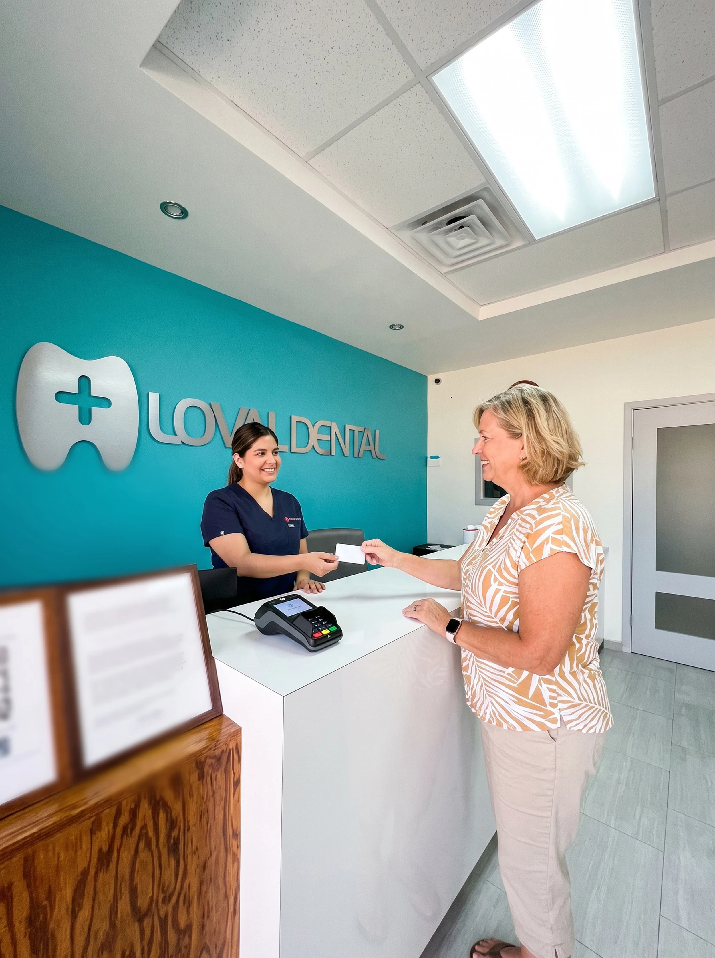 woman paying for dental care