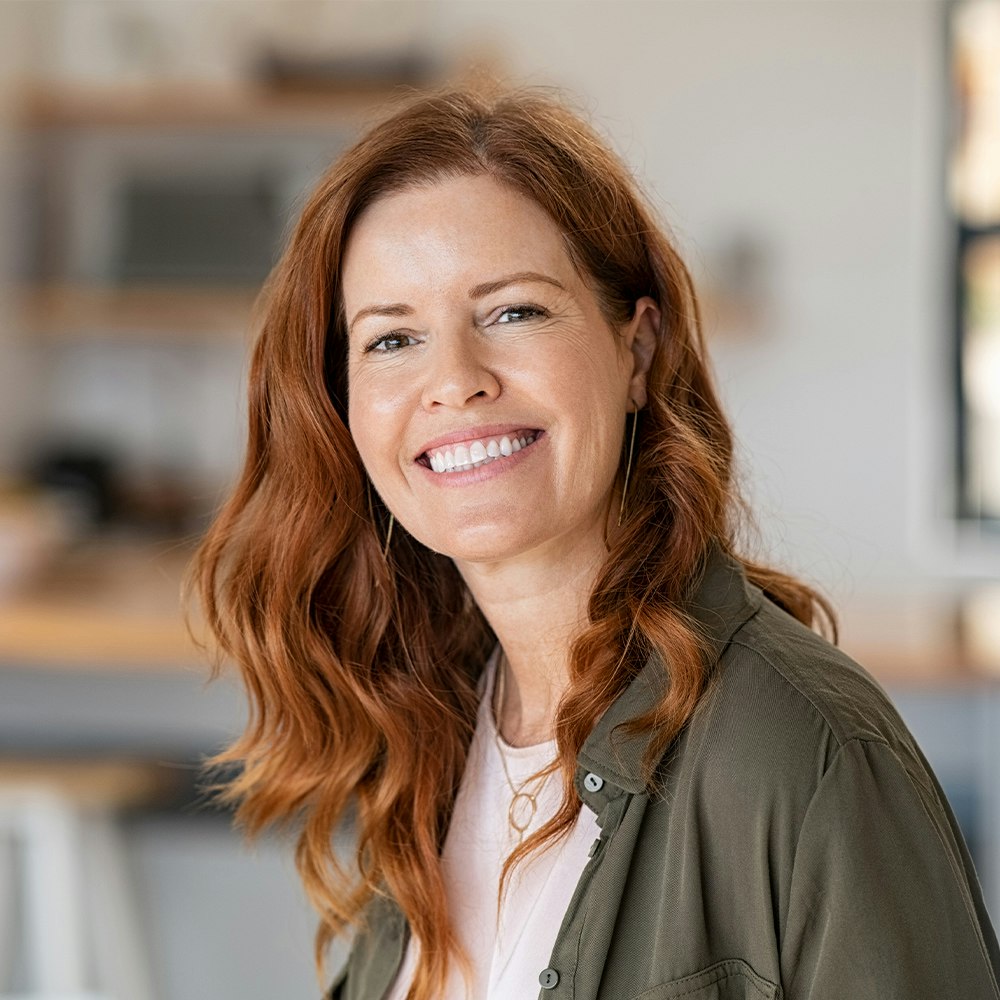 Smiling woman after dental bridge treatment