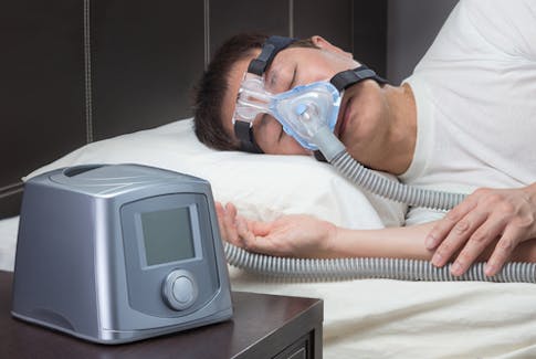 man sleeping with CPAP mask on 