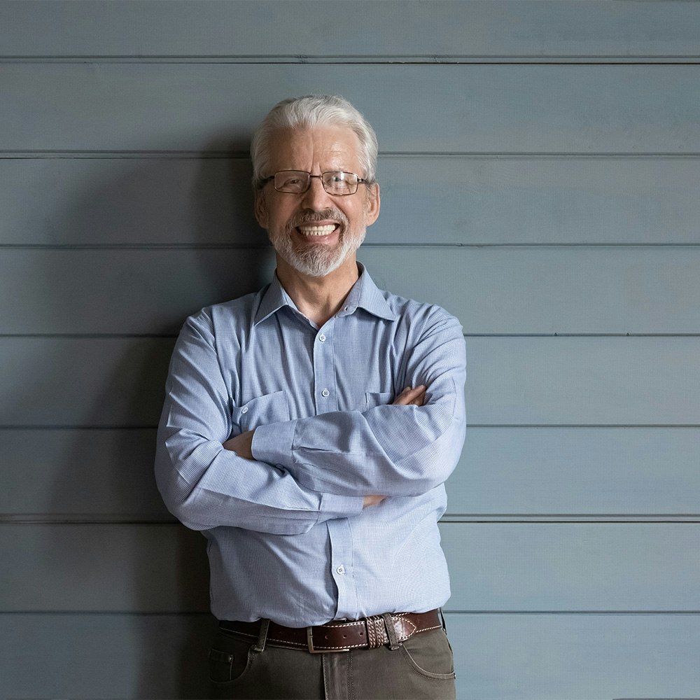 Older man with dental implants smiling