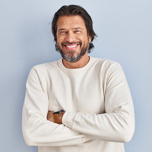 Man smiling with crossed arms