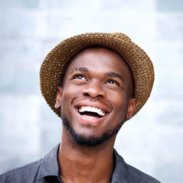 Young man smiling in a hat