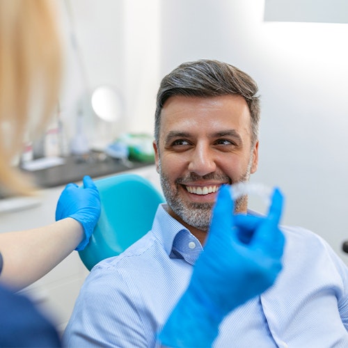 smiling invisalign patient with dentist