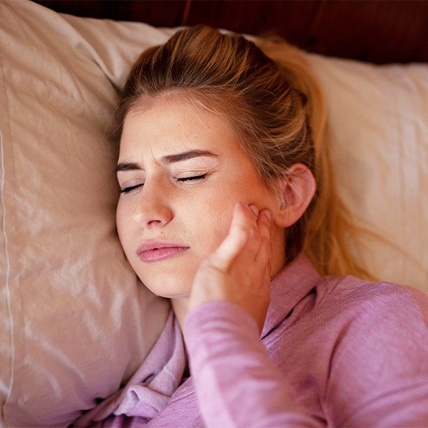 a woman with a sore jaw