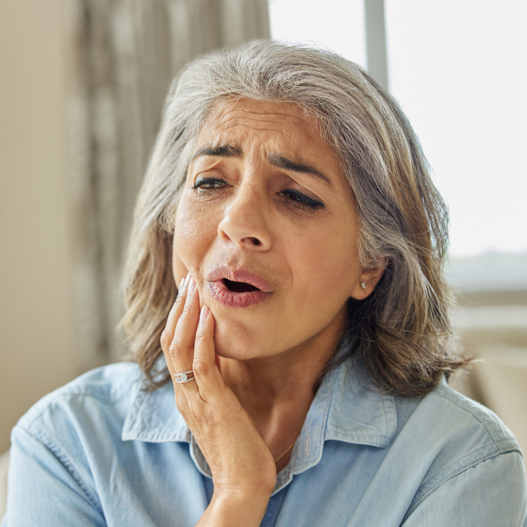 Woman in pain who needs a root canal