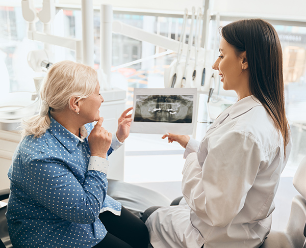 dentist and patient looking at an X-ray