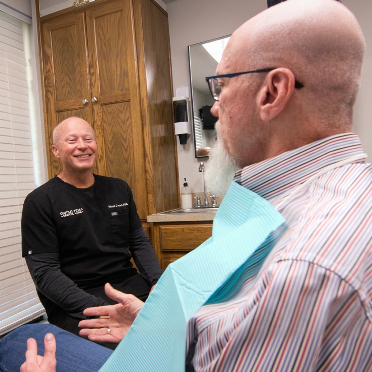 Dentist chatting with patient