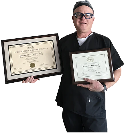 Bernardino A. Arocha, M.D. holding diplomas