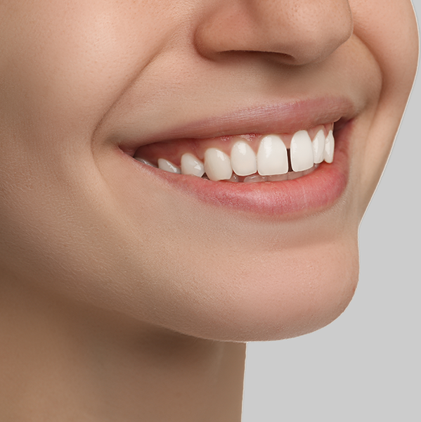 Close up of a person's smile with a small gap in their front teeth