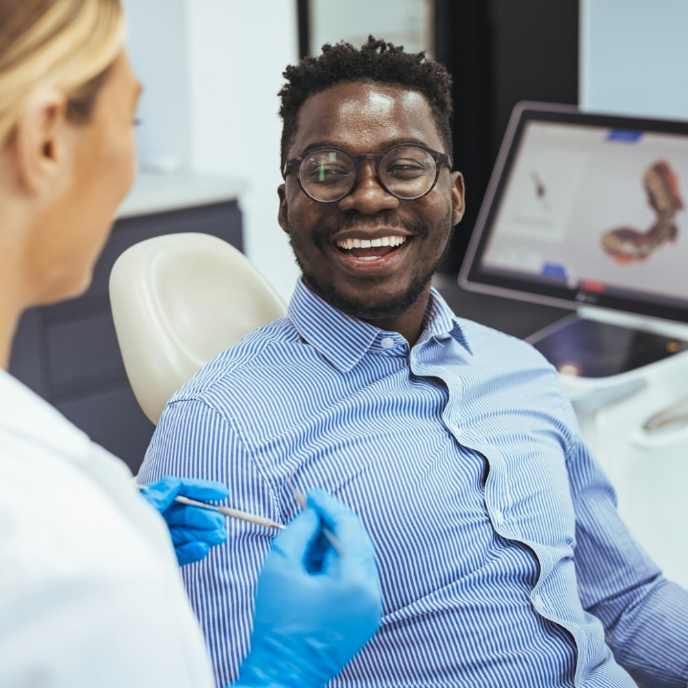 A man smiling in the dentist chair