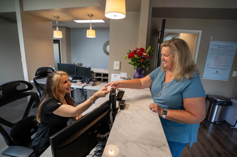 Atlanta West Dentistry team member helping a patient at the front desk