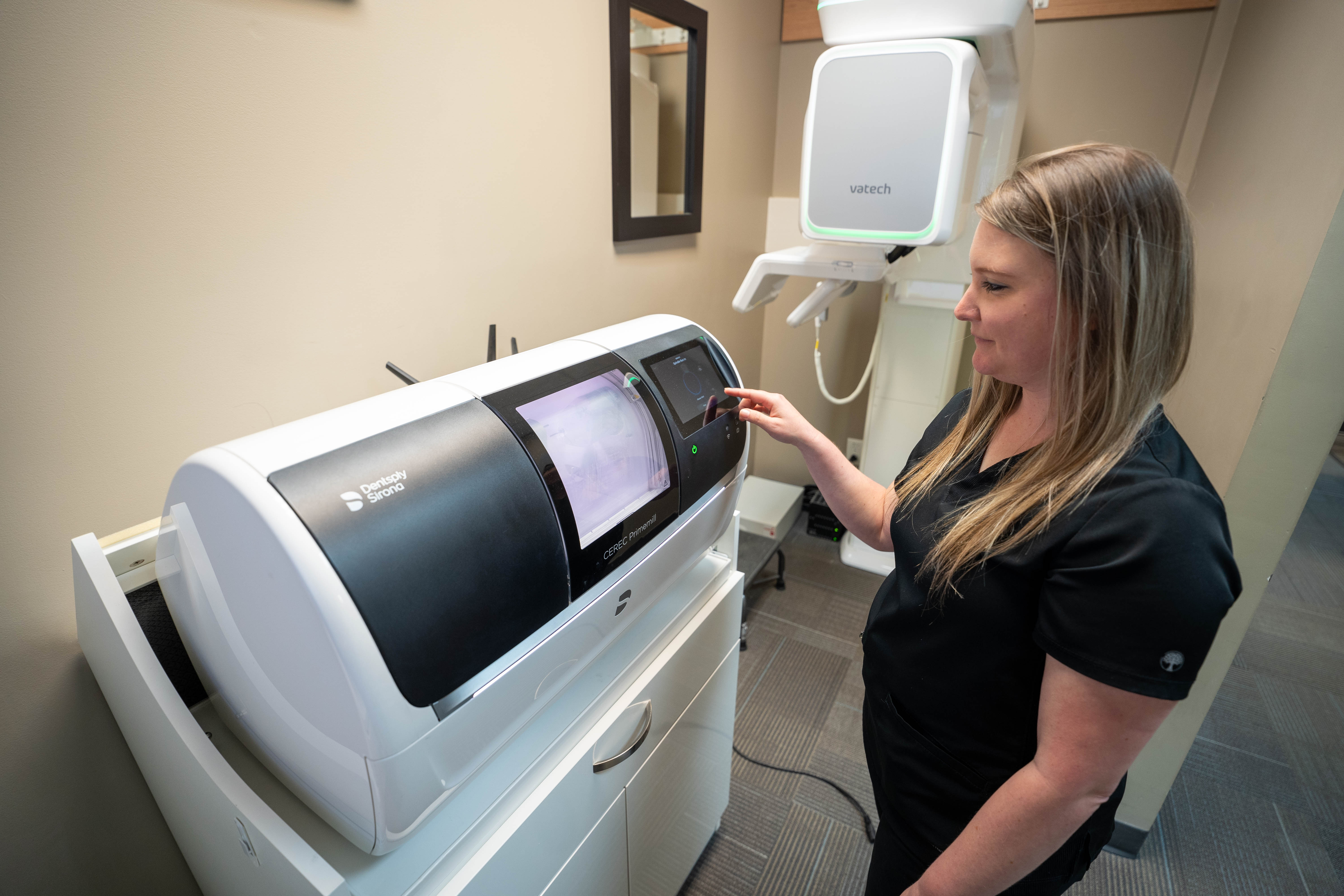 Staff member working with CEREC machine