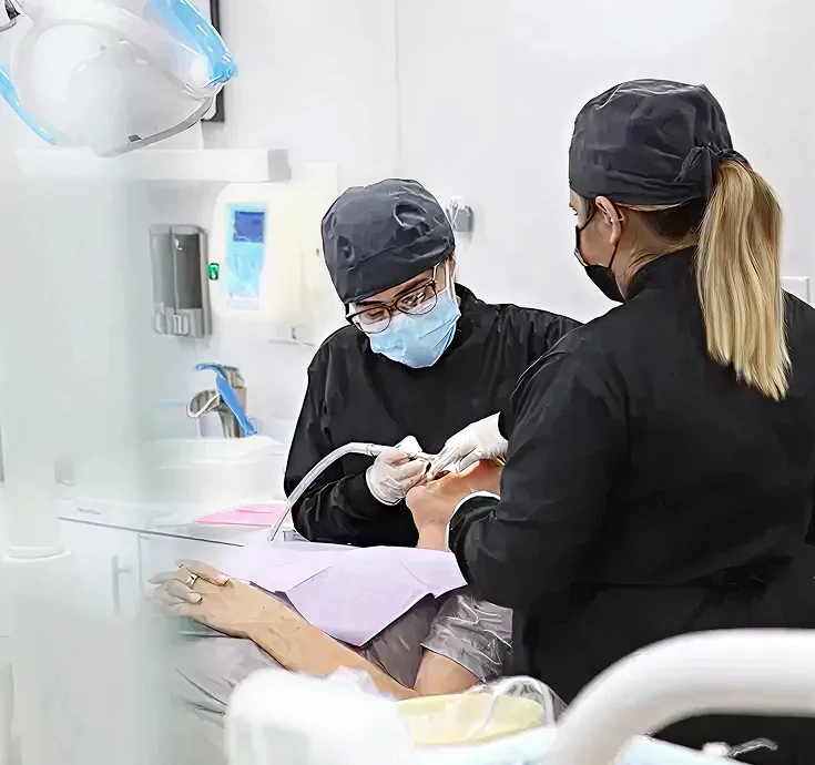 team at supreme dental working on patient