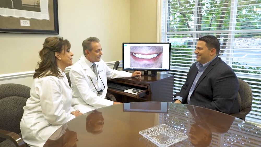 the Cosmetic Dentistry Institute team consulting with a patient