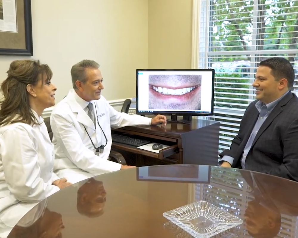 the Cosmetic Dentistry Institute team consulting with a patient