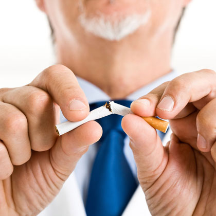 person breaking a cigarette in half