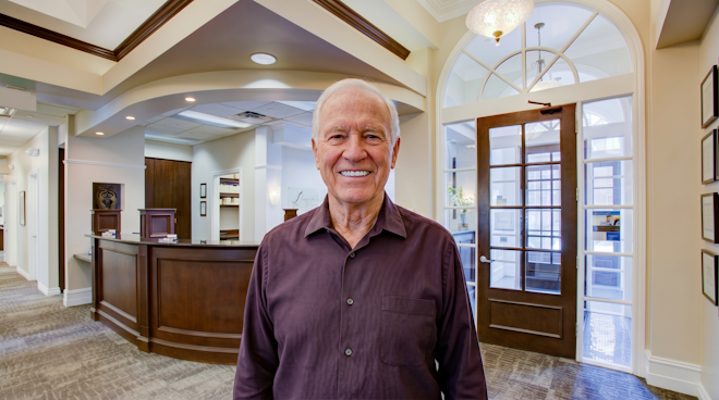 elderly man smiling in lobby