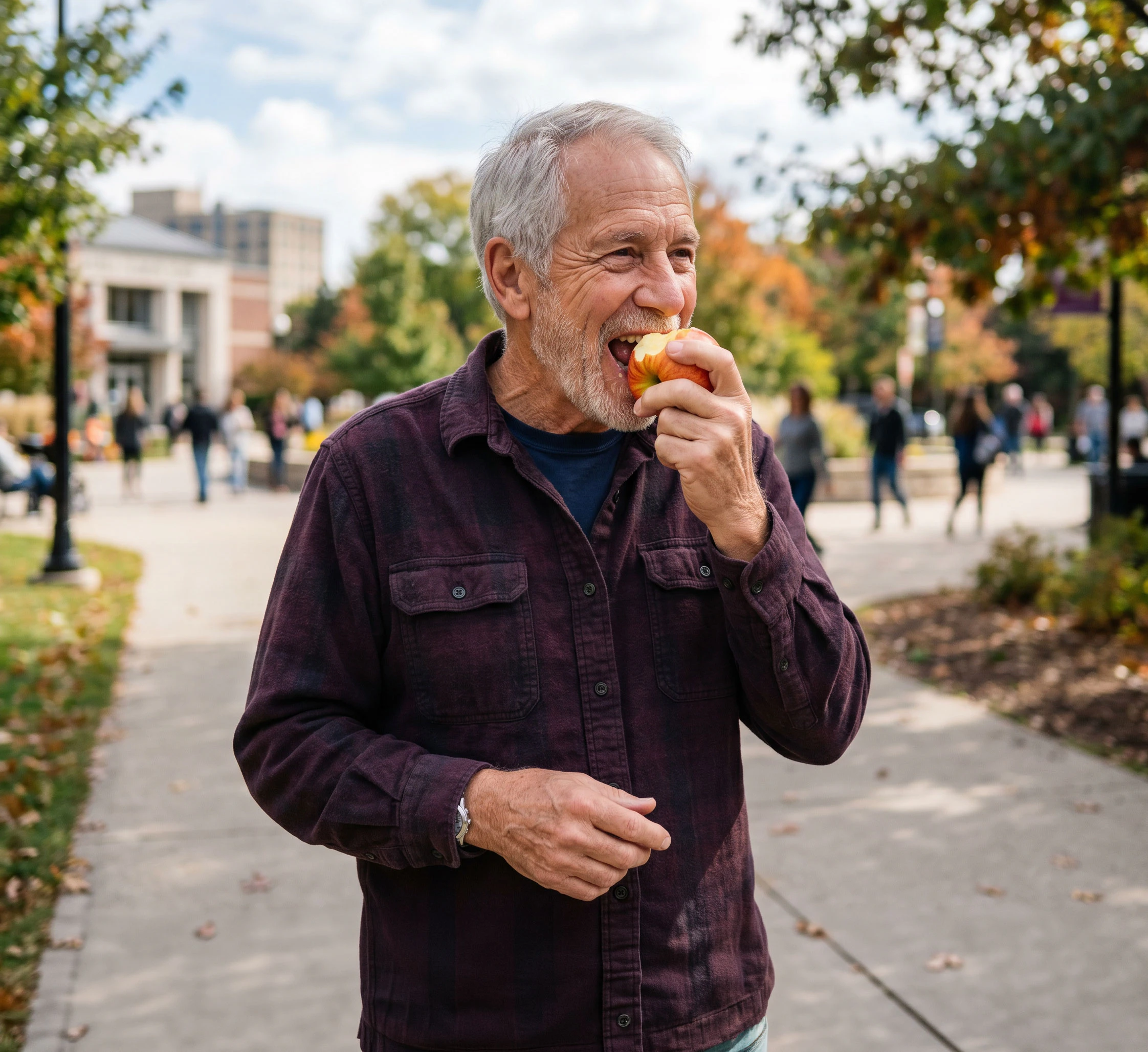 Elderly man biting into an apple